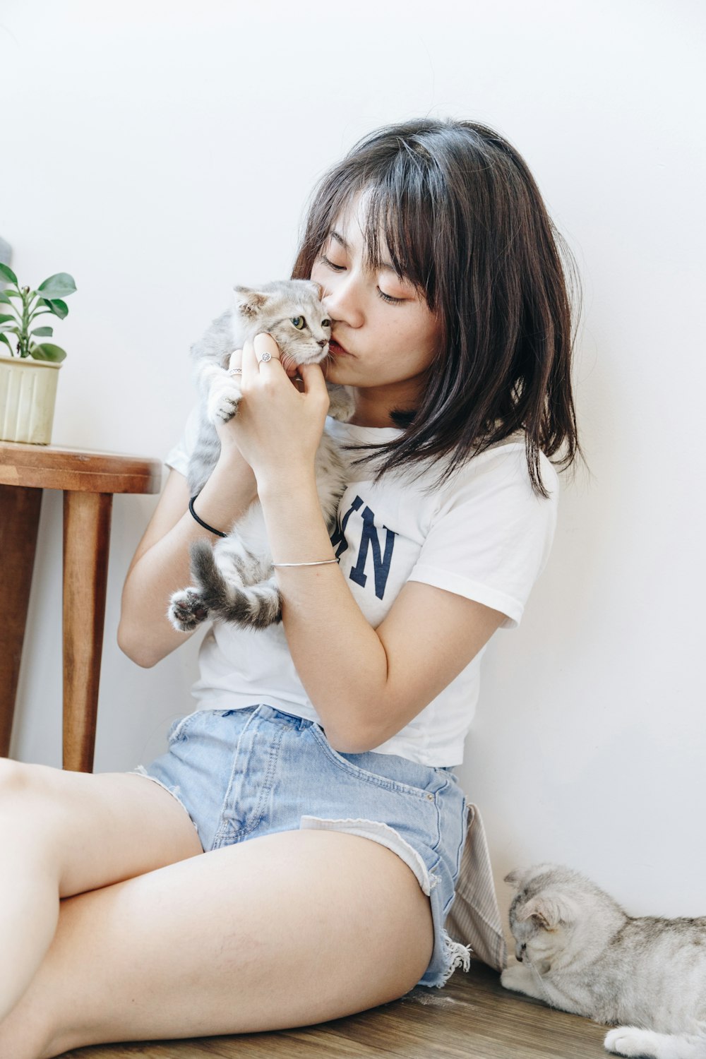 A woman kissing her cat
